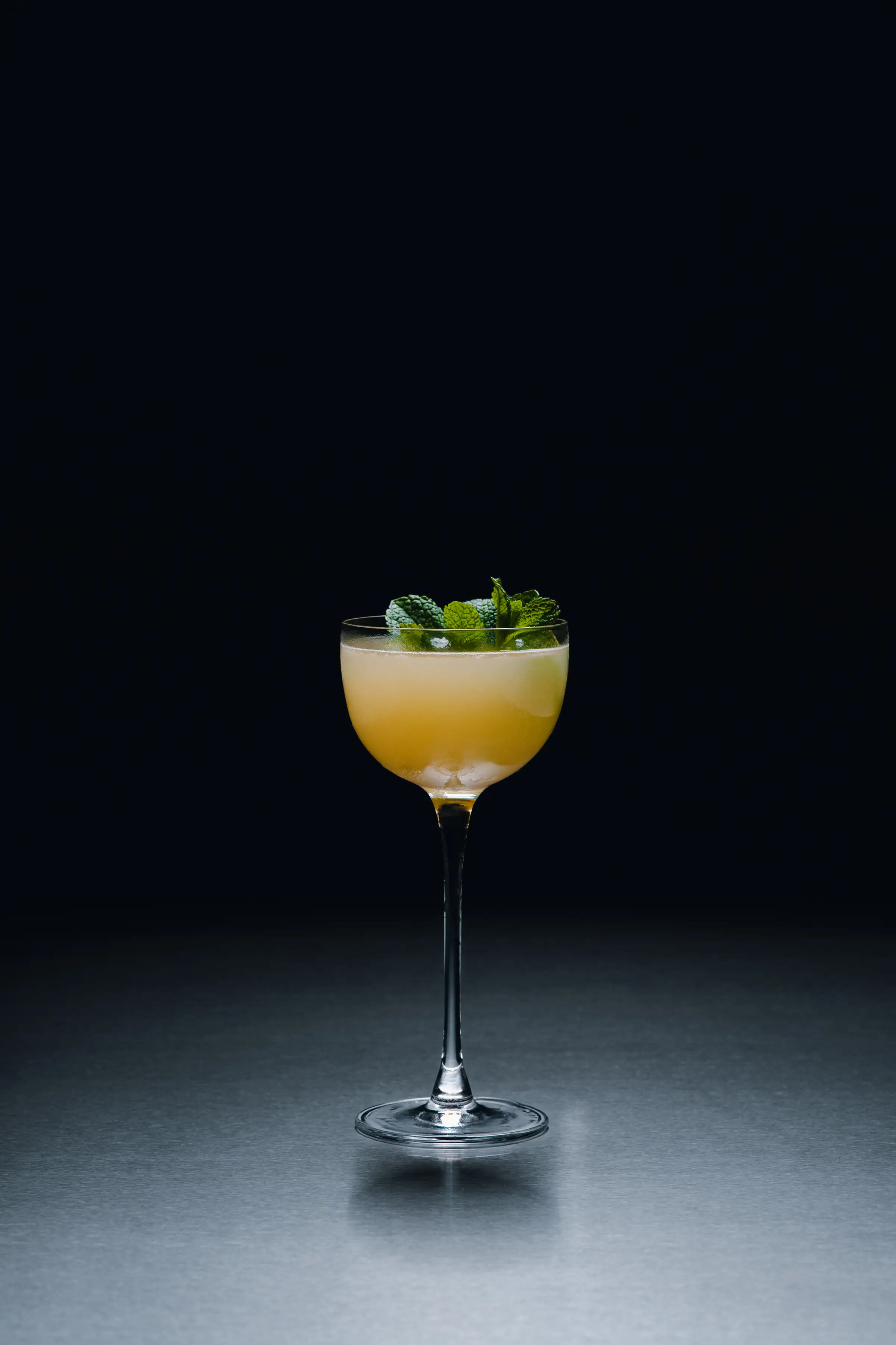 A short cocktail finished with mint at the bar of Holographik Space