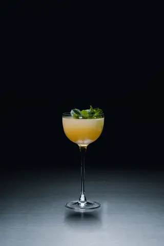 A short cocktail finished with mint at the bar of Holographik Space