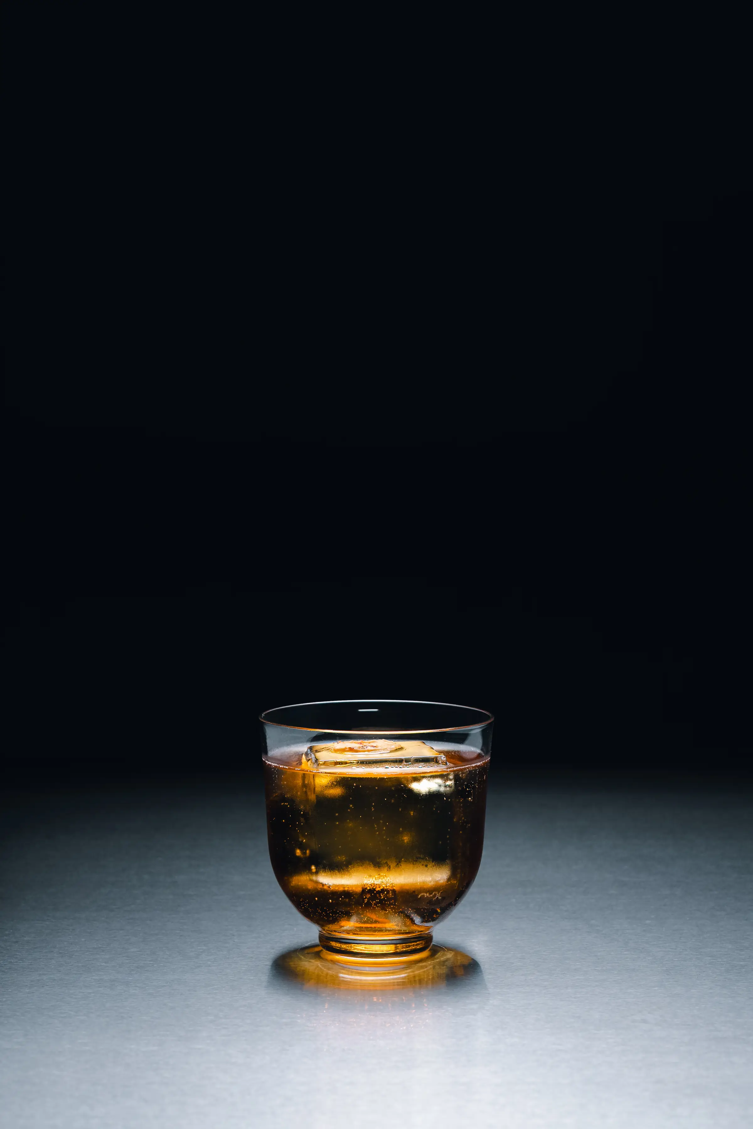A spirit served over ice at the bar of Holographik Space
