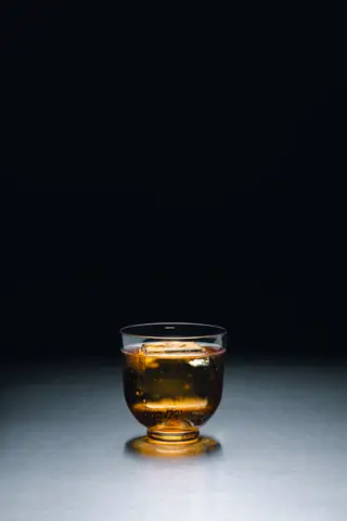 A spirit served over ice at the bar of Holographik Space